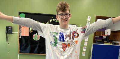 An ISP1 Student showing off the T-Shirt they made.